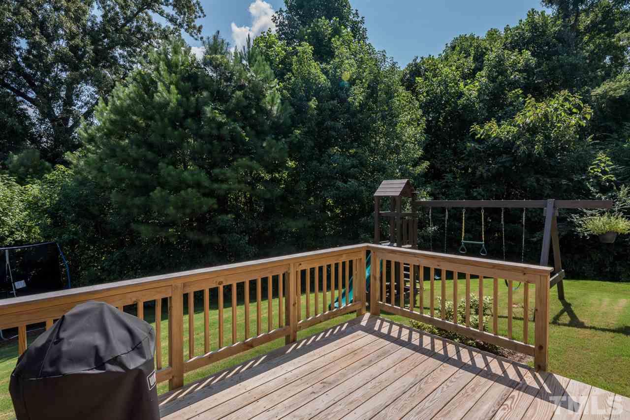 107 Holyoke Court Raleigh, NC 27603 - Photo 17 of 25 Spend time on the privacy of your back deck looking at the beautiful trees.