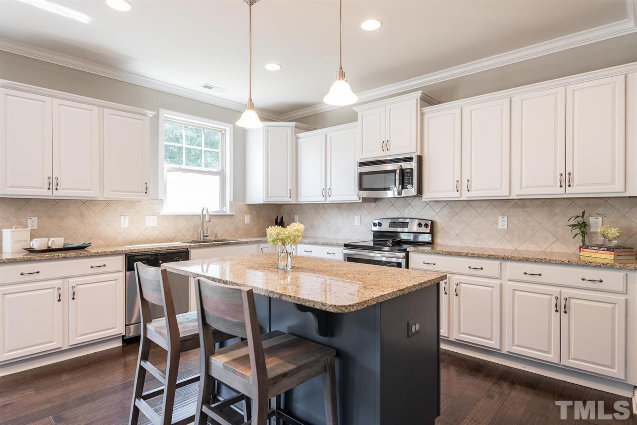 107 Holyoke Court Raleigh, NC 27603 - Photo 6 of 25 Grab a quick snack at the island.