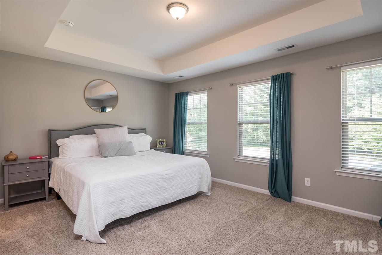 107 Holyoke Court Raleigh, NC 27603 - Photo 9 of 25 Simple and elegant master suite is located upstairs with a walk in closet.