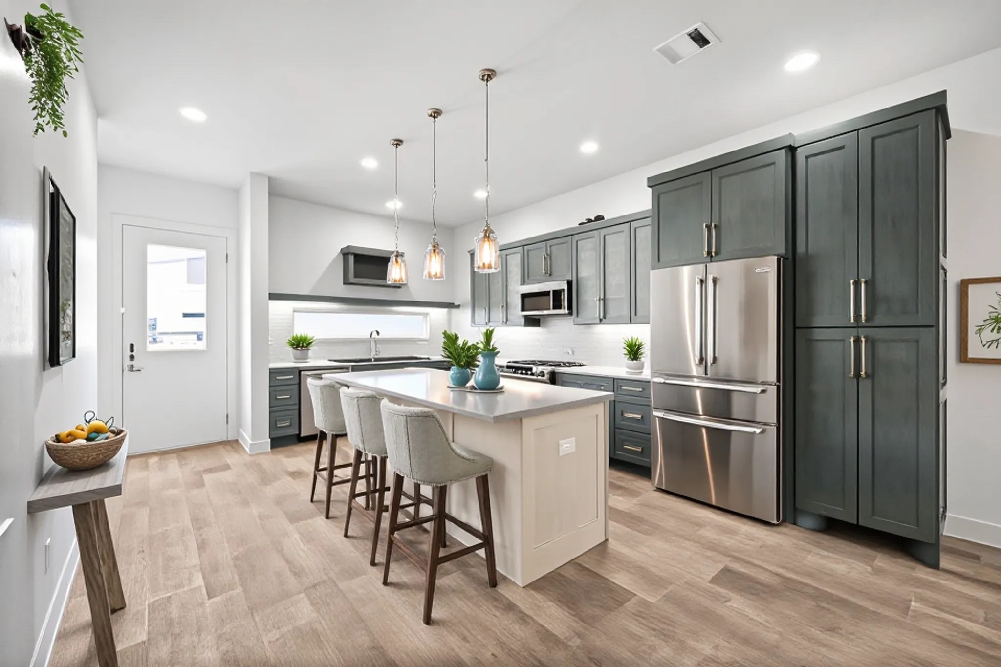 Step inside Troya and you're welcomed with this light and bright, open concept space. Virtually staged photo of the kitchen.
