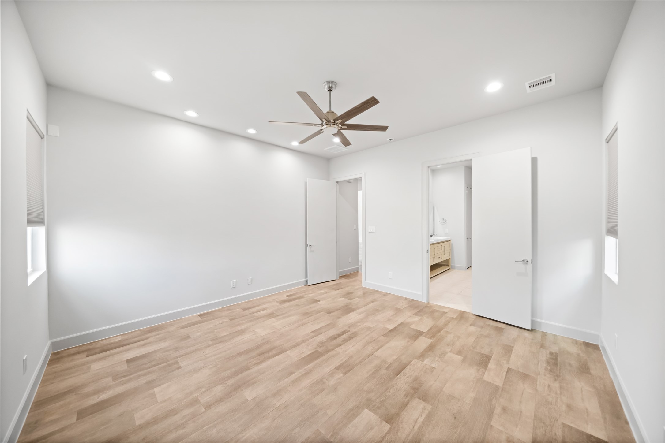 6809 Troya Lane Houston, TX 77092 - Photo 21 of 49 Spacious and serene primary bedroom featuring recessed lighting, neutral finishes, and direct access to a beautifully appointed en-suite bath.