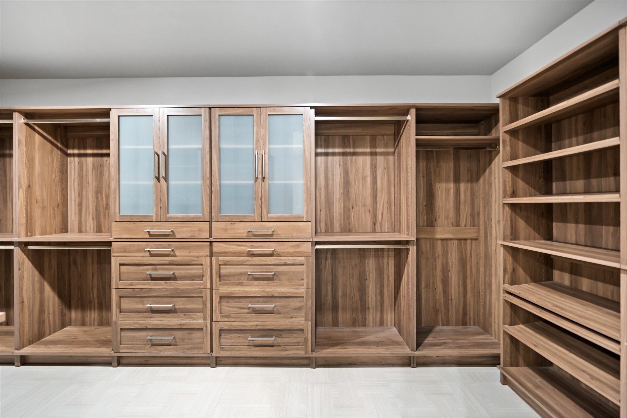 6809 Troya Lane Houston, TX 77092 - Photo 26 of 49 A fully built out custom closet with rich wood finishes, ample drawer space, open shelving, and hanging areas, designed to keep everything beautifully organized.