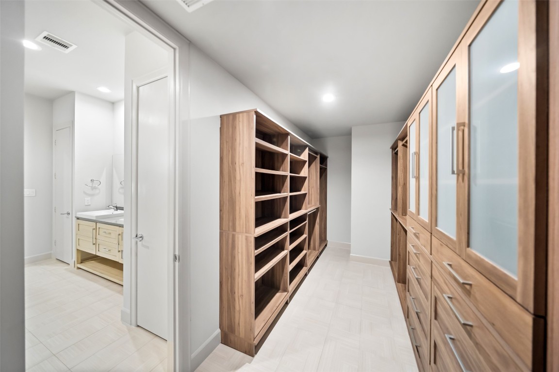 6809 Troya Lane Houston, TX 77092 - Photo 27 of 49 Another view of the expansive custom closet showcasing floor-to-ceiling storage and built-in shelving.