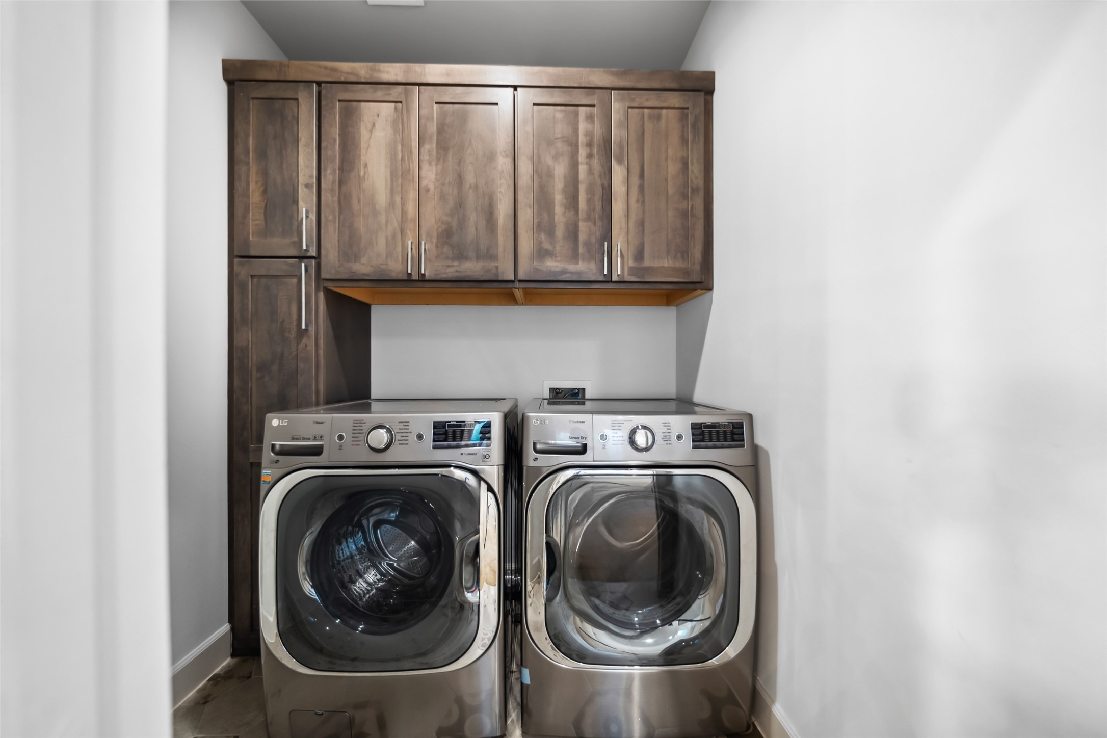 6809 Troya Lane Houston, TX 77092 - Photo 38 of 49 Dedicated laundry room with full-size washer and dryer, plus custom cabinetry for extra storage and organization.