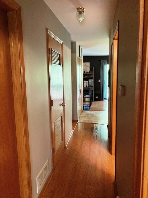1945 Matthew Court, Unit D Elgin, IL 60123 - Photo 14 of 22 a view of a hallway with wooden floor and a living room