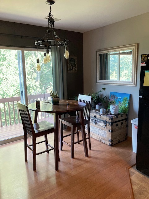 1945 Matthew Court, Unit D Elgin, IL 60123 - Photo 4 of 22 a dining room with furniture window entryway and wooden floor