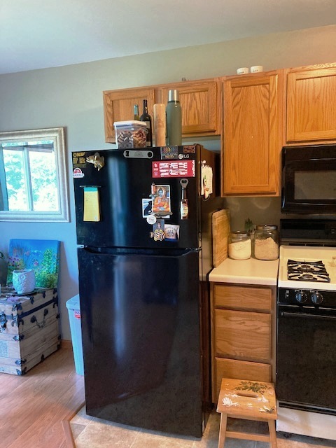 1945 Matthew Court, Unit D Elgin, IL 60123 - Photo 7 of 22 a kitchen with a refrigerator and a stove