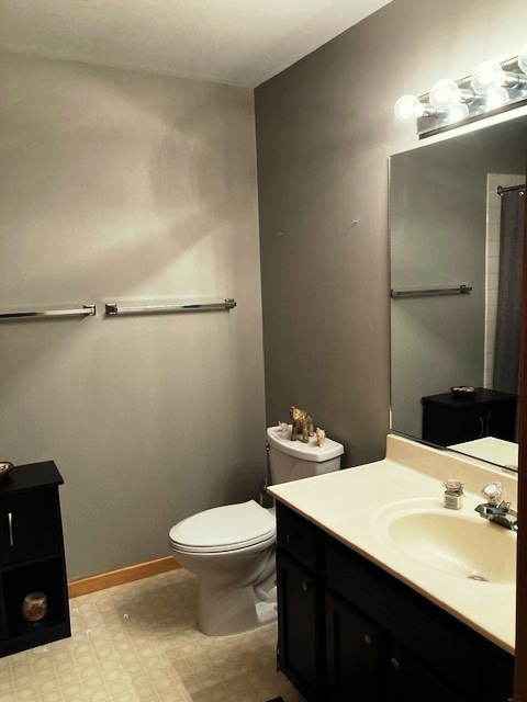 1945 Matthew Court, Unit D Elgin, IL 60123 - Photo 10 of 22 a bathroom with a sink a toilet and mirror
