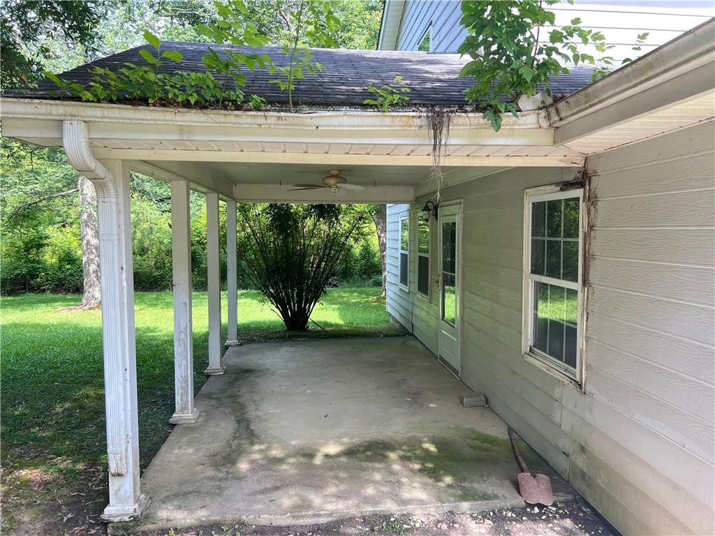 340 Womack Avenue Dallas, GA 30157 - Photo 10 of 29 a view of a porch with a floor to ceiling window plants and trees