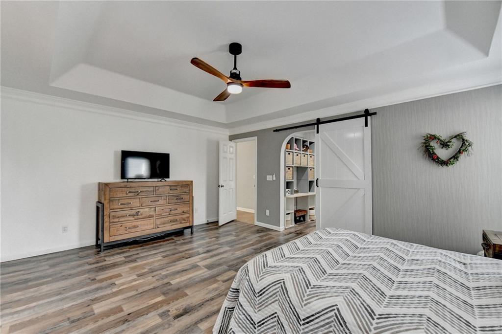 6435 Dressage Crossing Cumming, GA 30040 - Photo 16 of 35 a bedroom with a bed and a ceiling fan