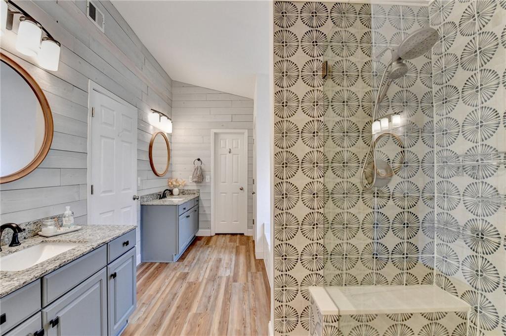 6435 Dressage Crossing Cumming, GA 30040 - Photo 20 of 35 a bathroom with a granite countertop sink and a mirror