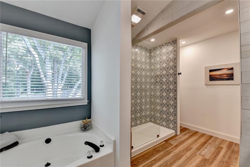 6435 Dressage Crossing Cumming, GA 30040 - Photo 21 of 35 a bathroom with a tub a sink and a shower