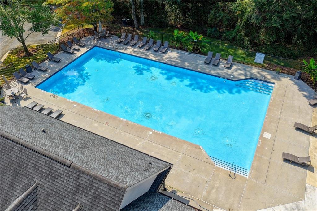 6435 Dressage Crossing Cumming, GA 30040 - Photo 34 of 35 a view of a swimming pool with lawn chairs plants and swimming pool