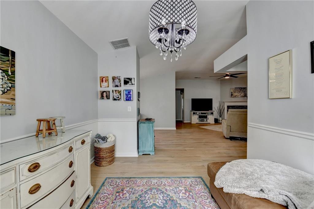 6435 Dressage Crossing Cumming, GA 30040 - Photo 5 of 35 a spacious bedroom with a bed and a chandelier