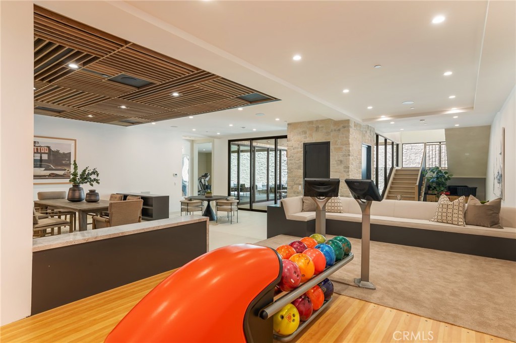 24255 Bridle Trail Road Hidden Hills, CA 91302 - Photo 16 of 52 a living room with furniture a wooden floor and kitchen view