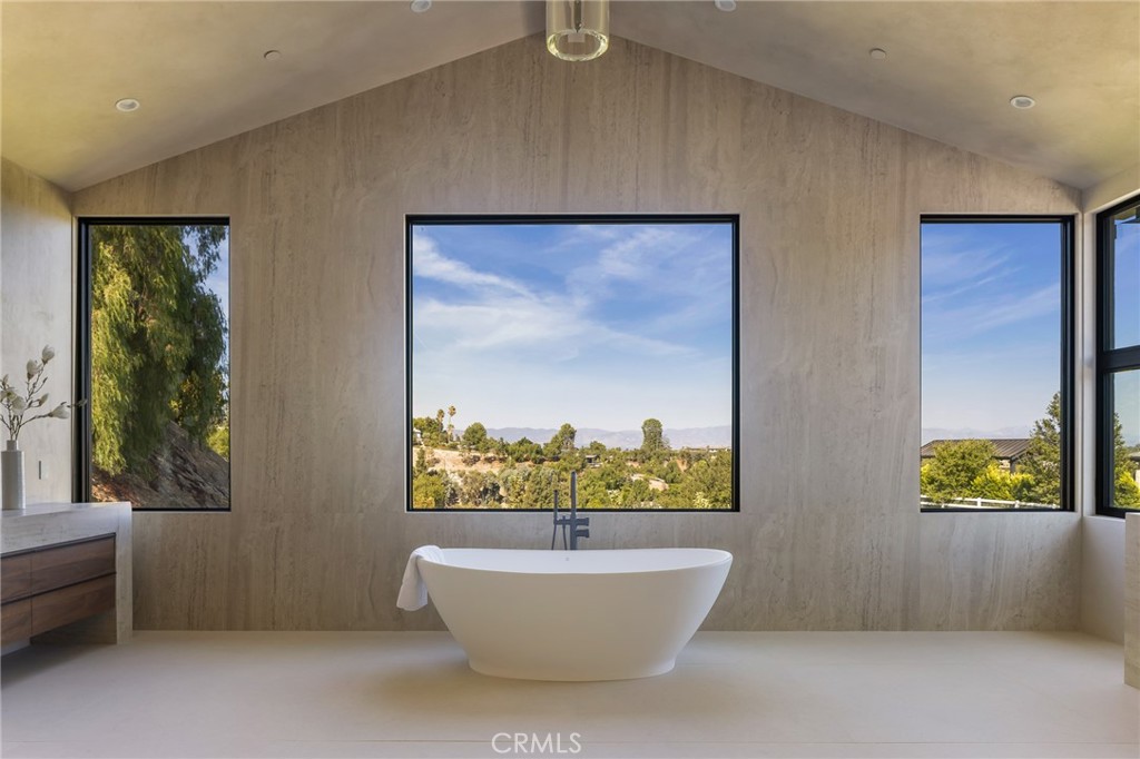 24255 Bridle Trail Road Hidden Hills, CA 91302 - Photo 29 of 52 a bathroom with a bathtub and window