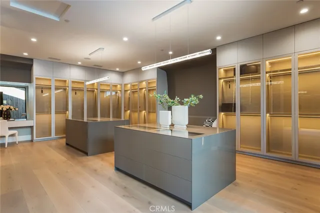 a lobby with glass door and chandelier
