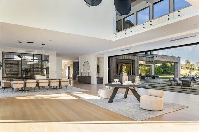 a living room with furniture and a floor to ceiling window