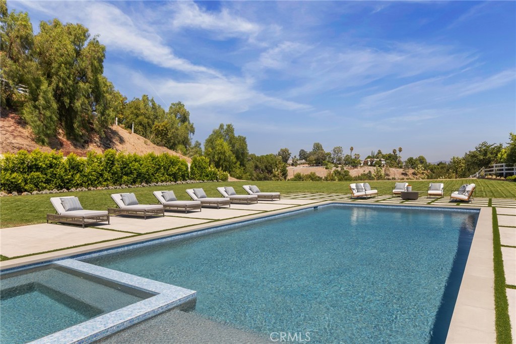 24255 Bridle Trail Road Hidden Hills, CA 91302 - Photo 45 of 52 a view of a swimming pool and city from a balcony