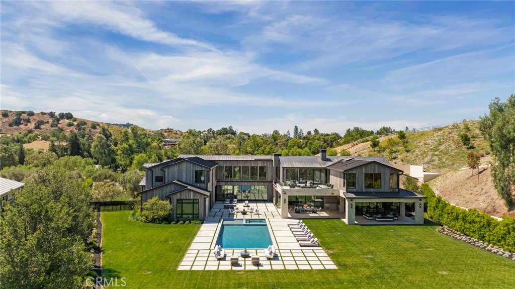 24255 Bridle Trail Road Hidden Hills, CA 91302 - Photo 46 of 52 a view of a house with a big yard plants and large trees