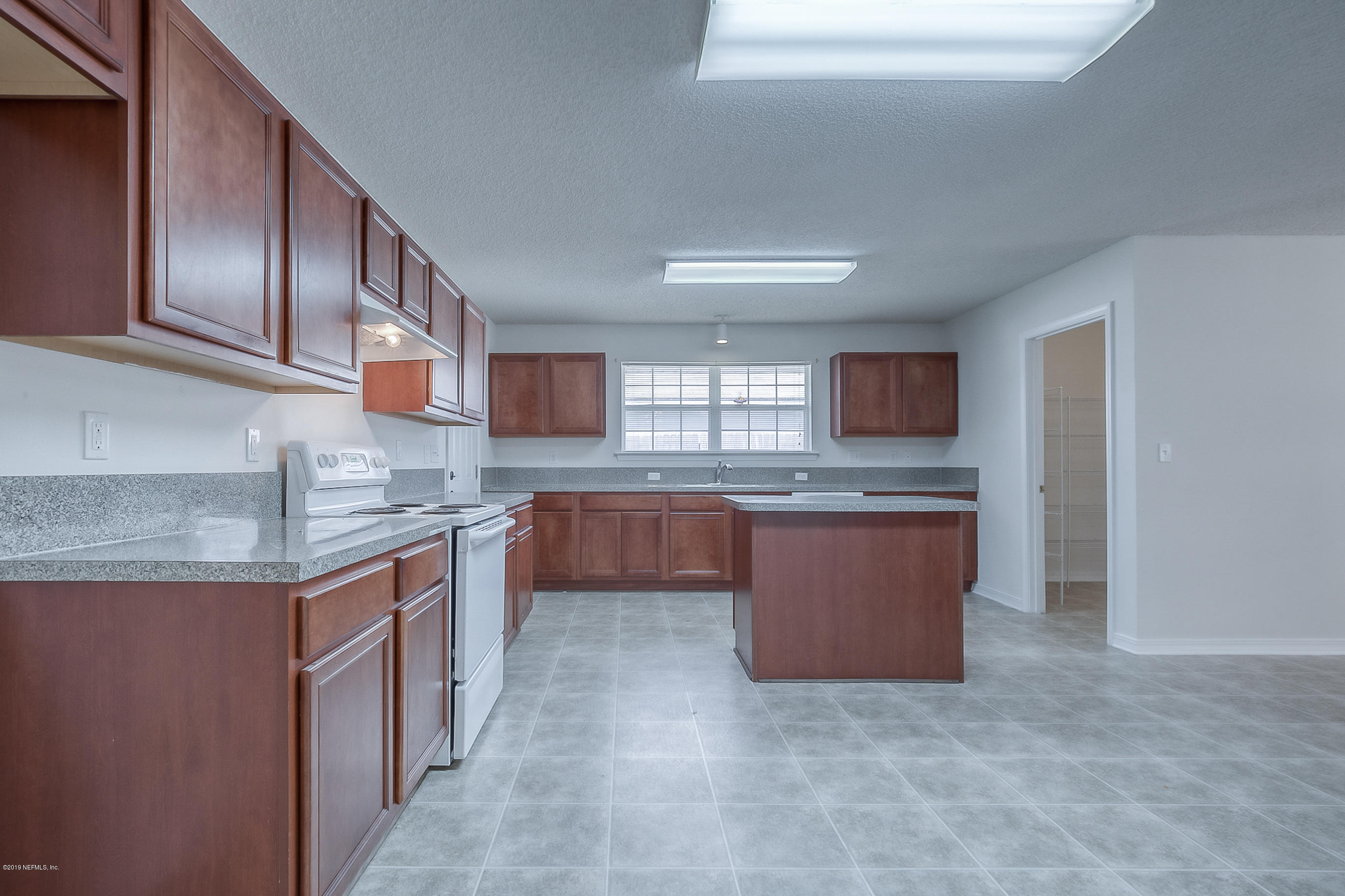 2633 Springwillow Drive Jacksonville, FL 32221 - Photo 11 of 33 a large kitchen with stainless steel appliances granite countertop a stove and a sink