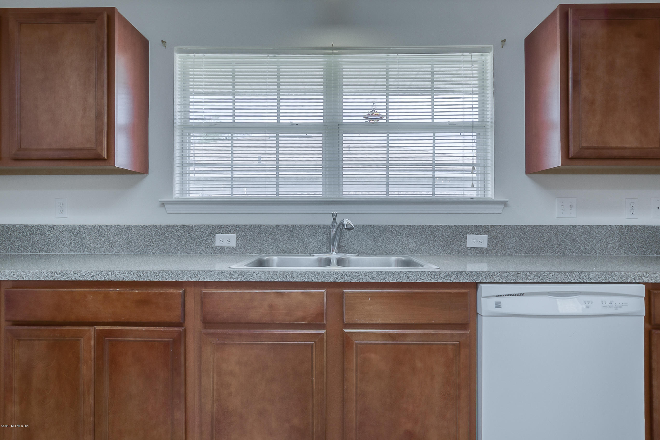 2633 Springwillow Drive Jacksonville, FL 32221 - Photo 14 of 33 a kitchen with stainless steel appliances granite countertop white cabinets and a window