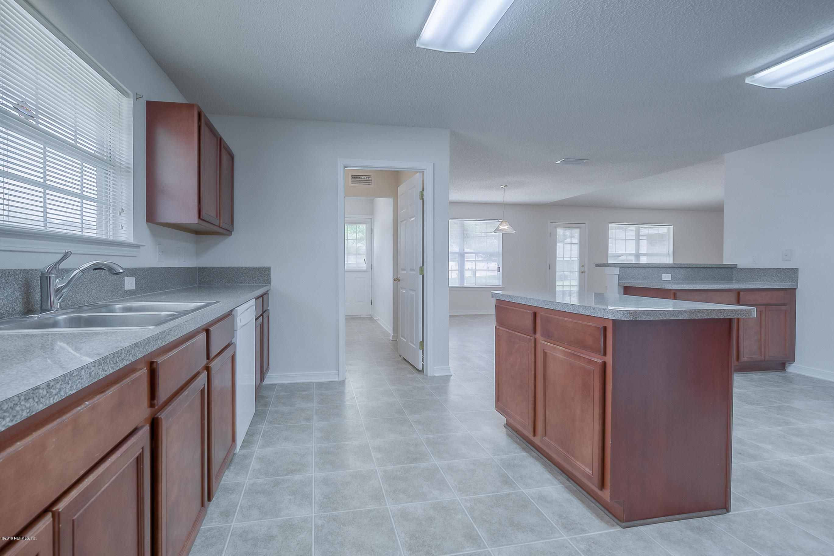 2633 Springwillow Drive Jacksonville, FL 32221 - Photo 15 of 33 a kitchen with stainless steel appliances granite countertop a sink and a stove