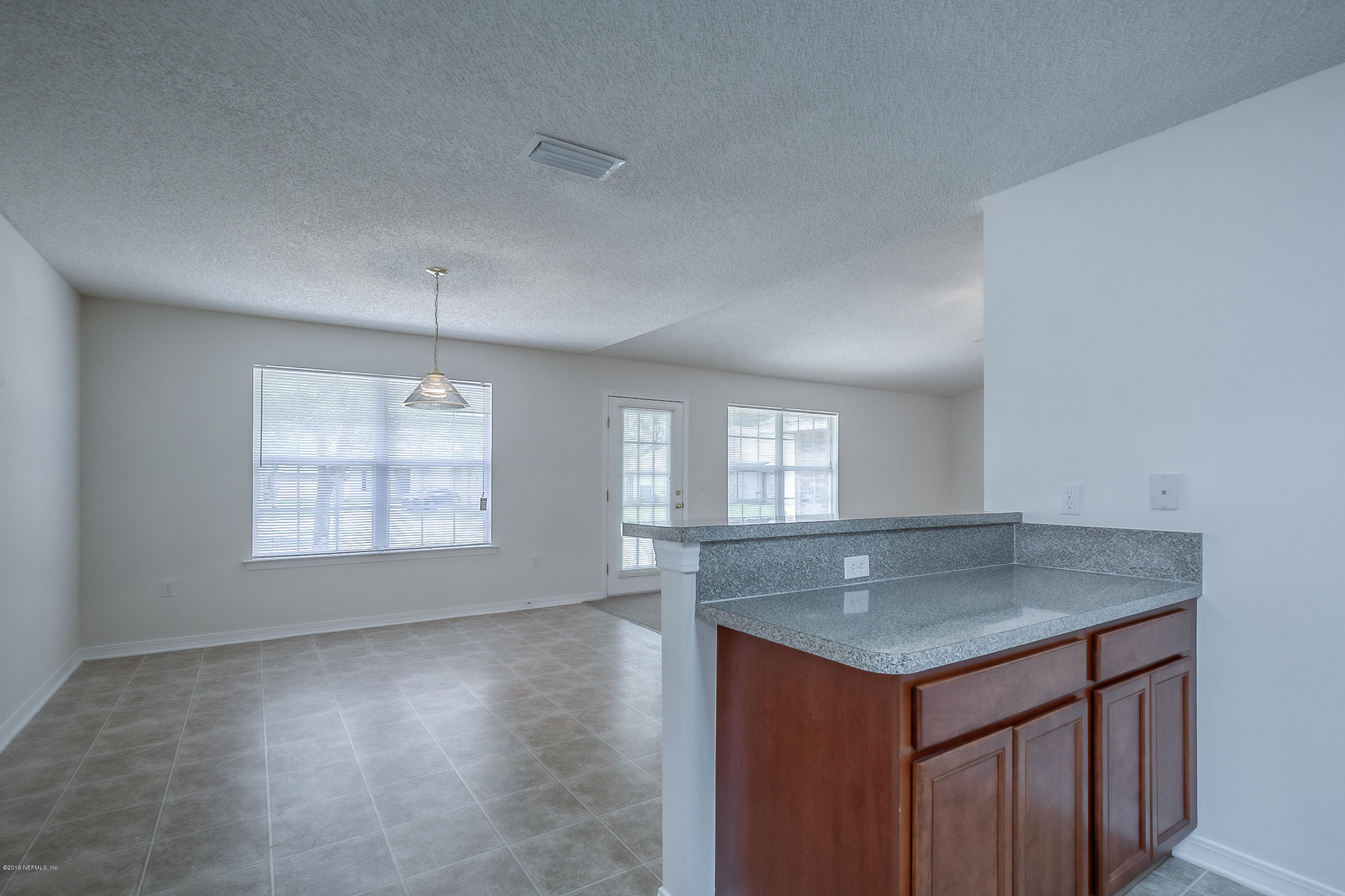 2633 Springwillow Drive Jacksonville, FL 32221 - Photo 17 of 33 an empty room with wooden floor and windows