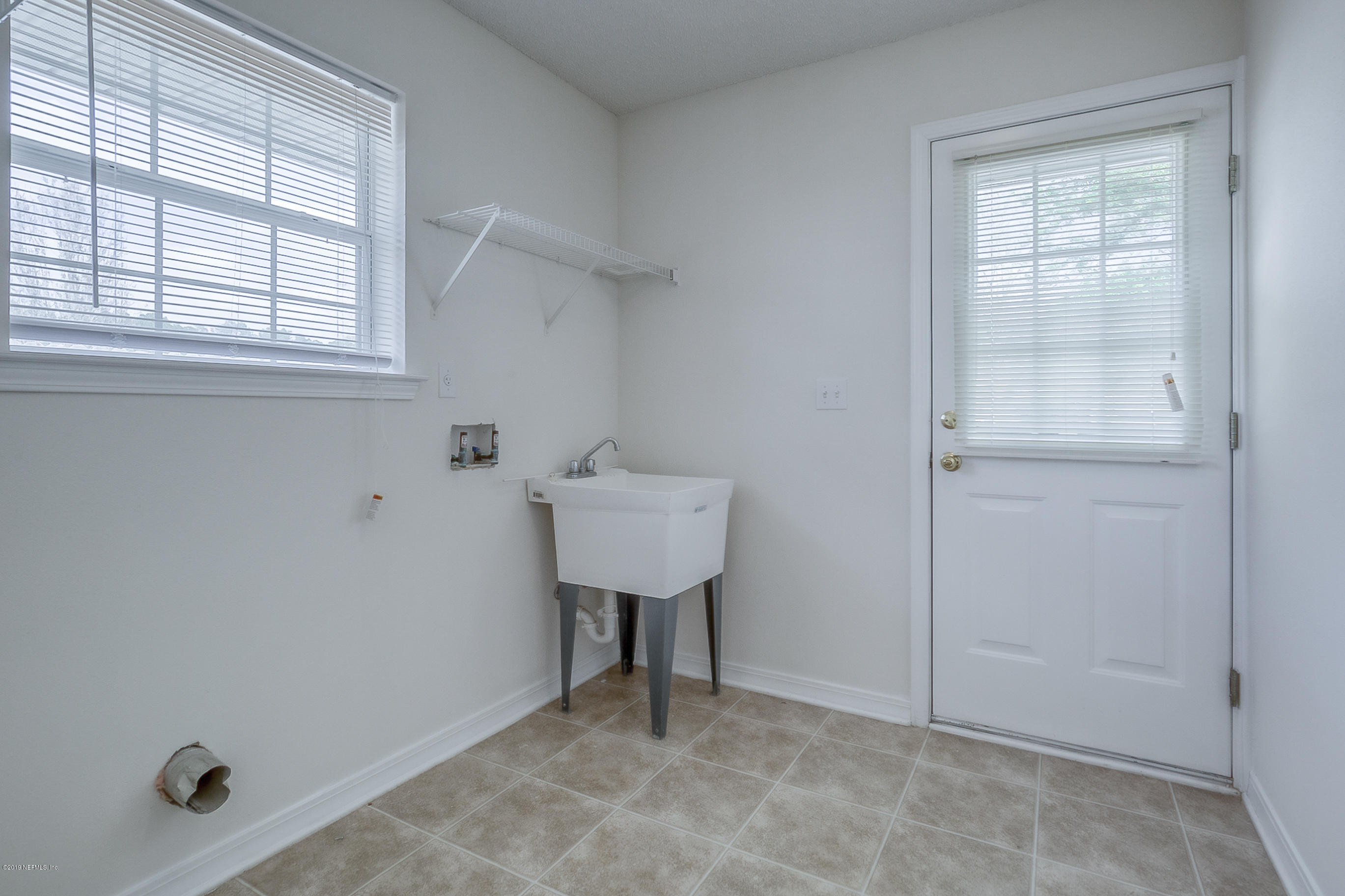 2633 Springwillow Drive Jacksonville, FL 32221 - Photo 19 of 33 a bathroom with a sink and a window