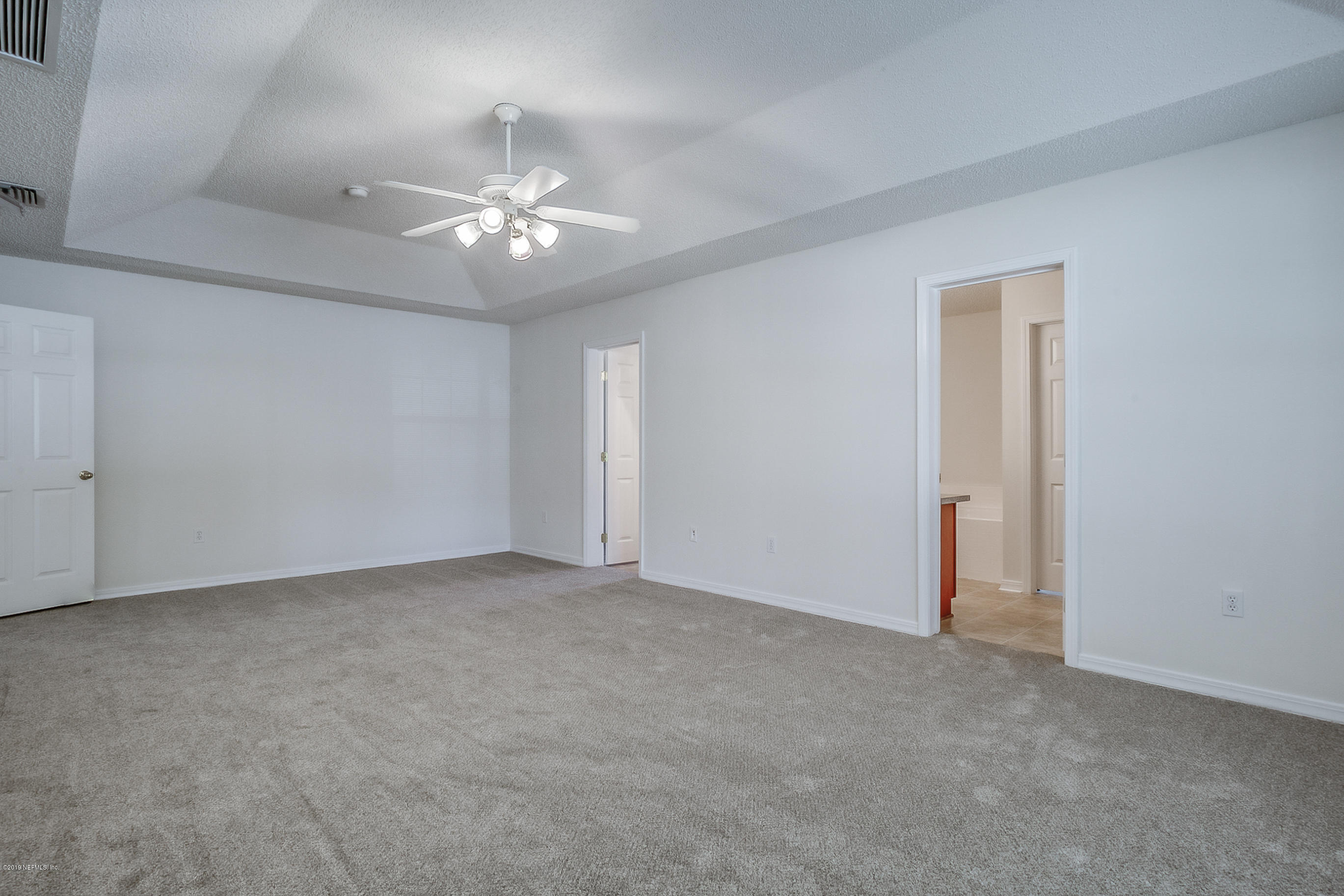 2633 Springwillow Drive Jacksonville, FL 32221 - Photo 22 of 33 an empty room with chandelier fan and windows