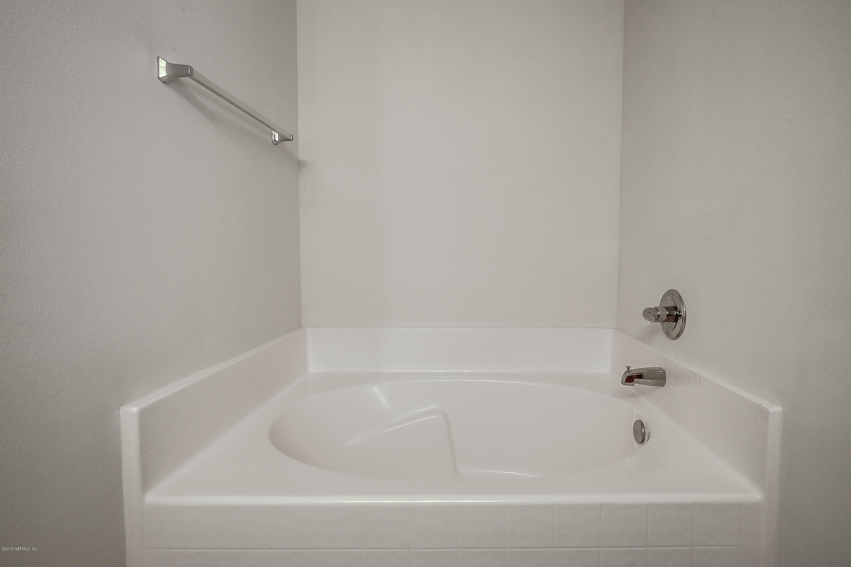 2633 Springwillow Drive Jacksonville, FL 32221 - Photo 24 of 33 a close up of a bathtub in a bathroom