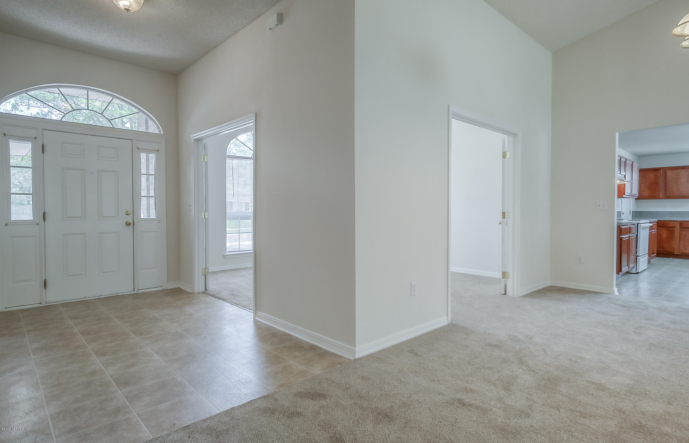 2633 Springwillow Drive Jacksonville, FL 32221 - Photo 5 of 33 an empty room with entrance and windows