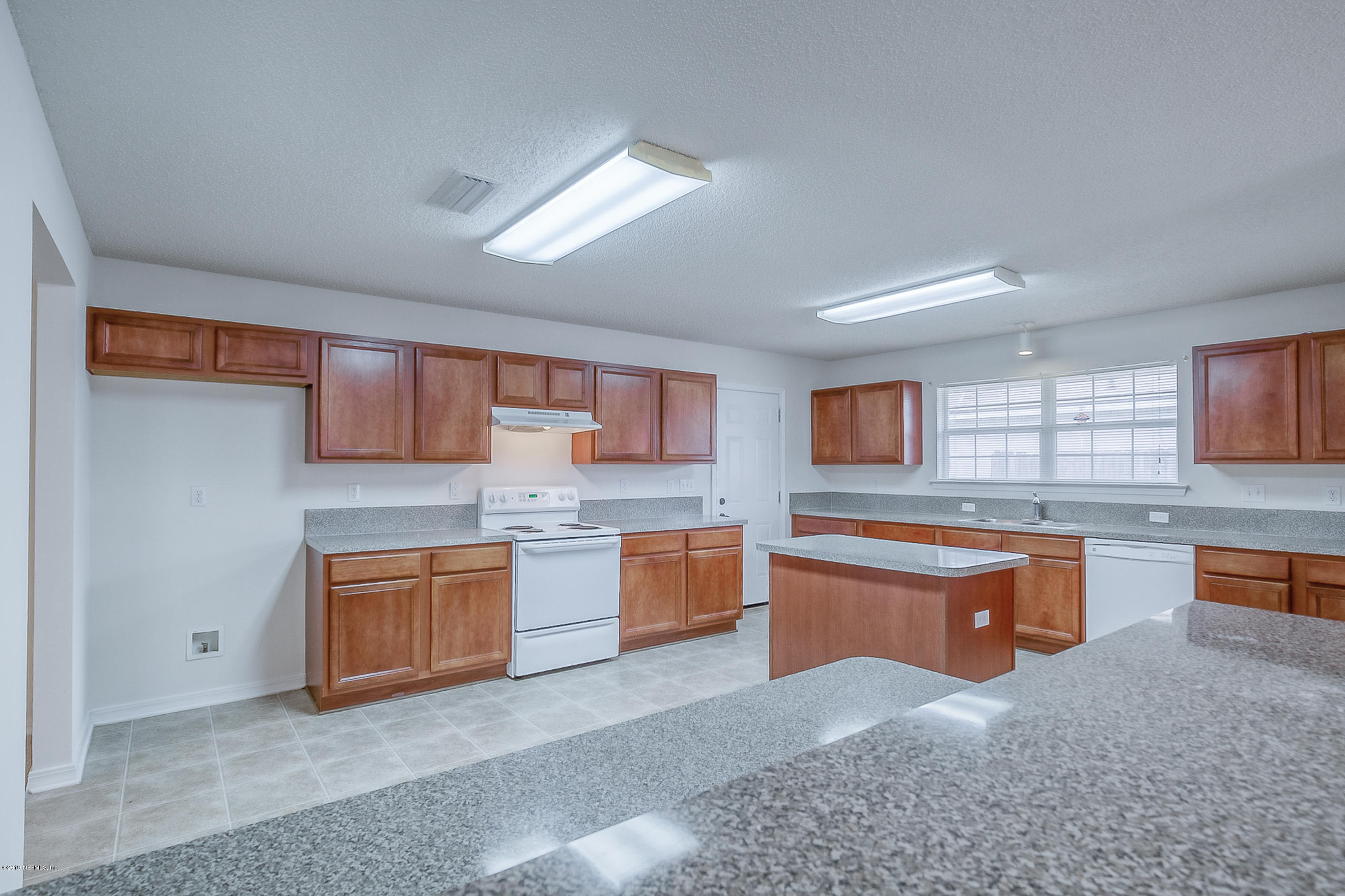 2633 Springwillow Drive Jacksonville, FL 32221 - Photo 10 of 33 a kitchen with stainless steel appliances granite countertop a sink dishwasher stove and cabinets