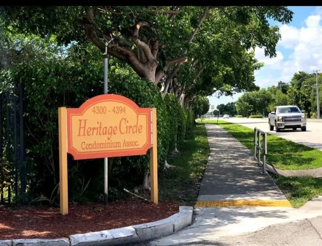 a view of a park with plants and large trees