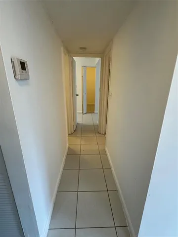 a view of hallway with walk in closet and window