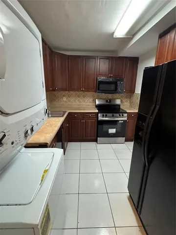 a kitchen with stainless steel appliances a stove a sink and a refrigerator