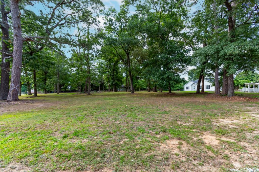 1042 Harbins Road Dacula, GA 30019 - Photo 12 of 33 a view of outdoor space with deck and trees