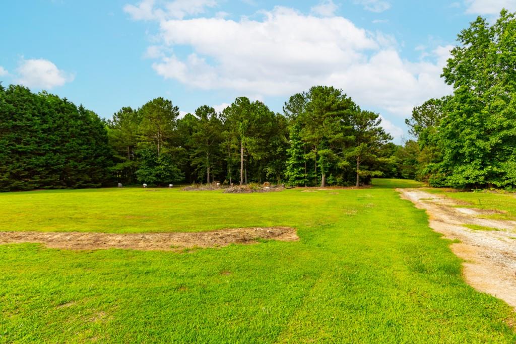 1042 Harbins Road Dacula, GA 30019 - Photo 24 of 33 a view of yard with swimming pool and green space