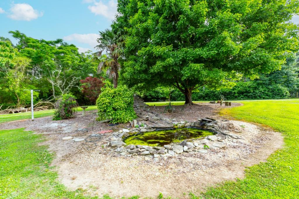 1042 Harbins Road Dacula, GA 30019 - Photo 30 of 33 a view of a swimming pool with a yard