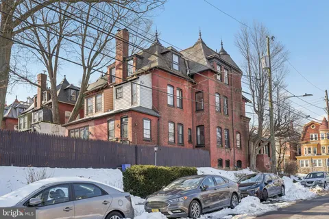 a front view of a building with parking space