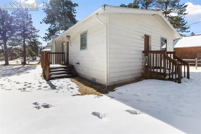 a view of a house with wooden fence