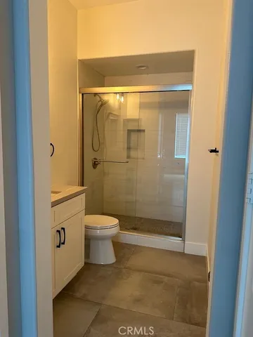 a bathroom with a toilet and shower