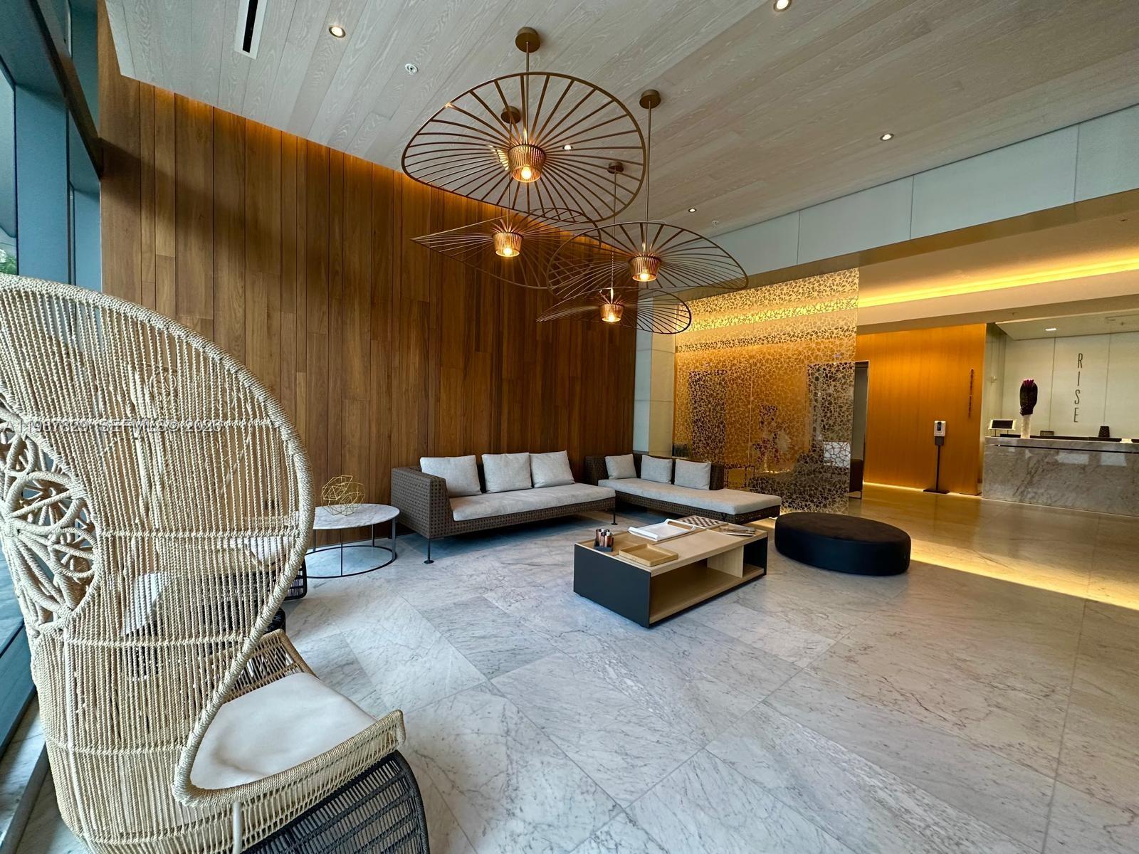 88 Southwest 7th Street, Unit 3609 Miami, FL 33130 - Photo 12 of 25 a living room with furniture and a chandelier