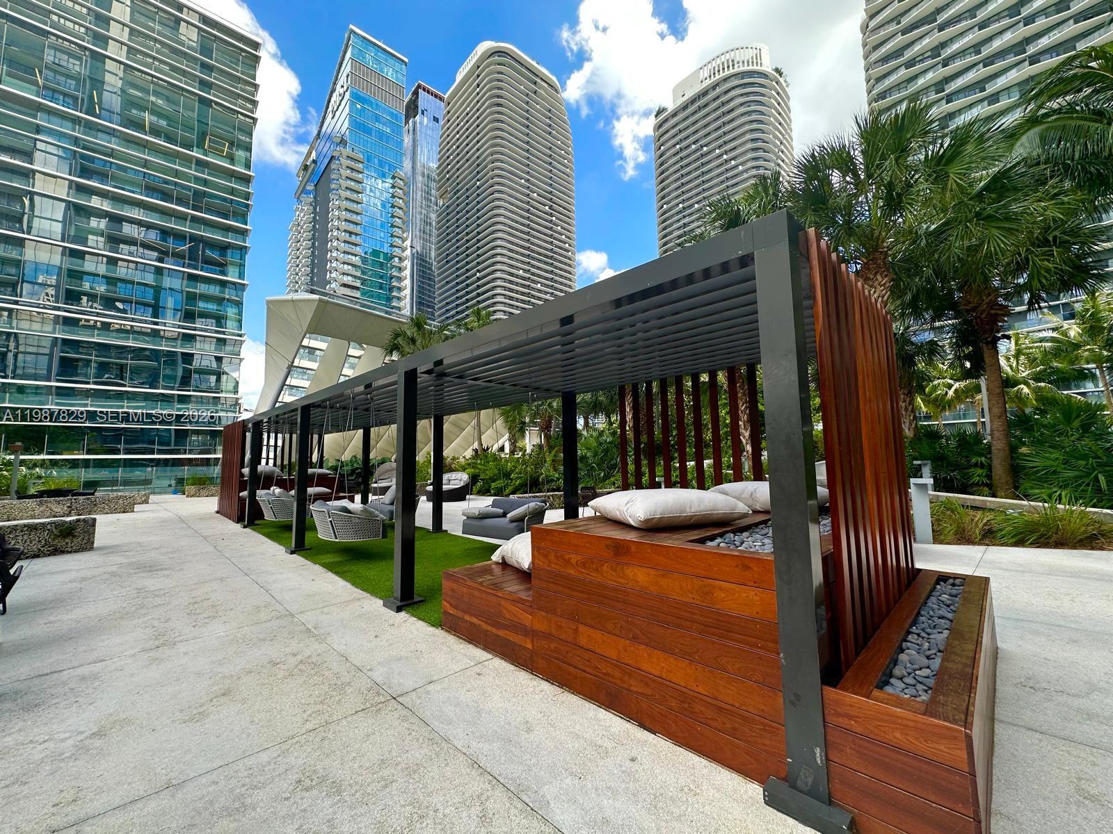 88 Southwest 7th Street, Unit 3609 Miami, FL 33130 - Photo 16 of 25 a view of a patio with table and chairs and potted plants