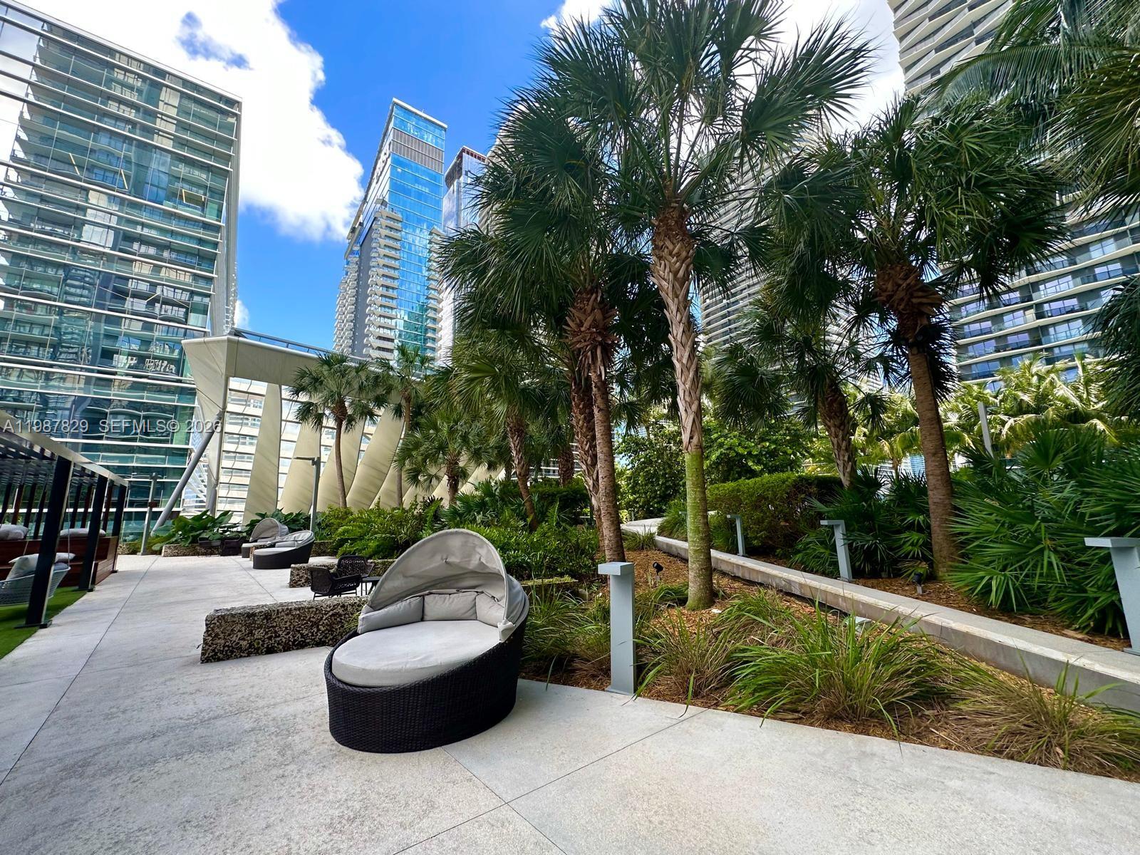 88 Southwest 7th Street, Unit 3609 Miami, FL 33130 - Photo 18 of 25 a view of a patio with couches and a fire pit