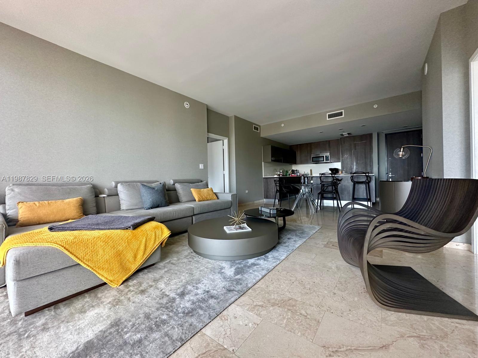 88 Southwest 7th Street, Unit 3609 Miami, FL 33130 - Photo 3 of 25 a living room with furniture and a couch