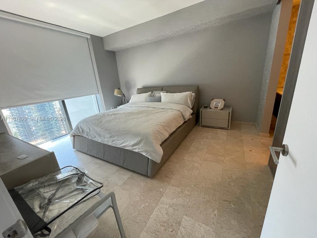 88 Southwest 7th Street, Unit 3609 Miami, FL 33130 - Photo 8 of 25 a bedroom with a bed and a window