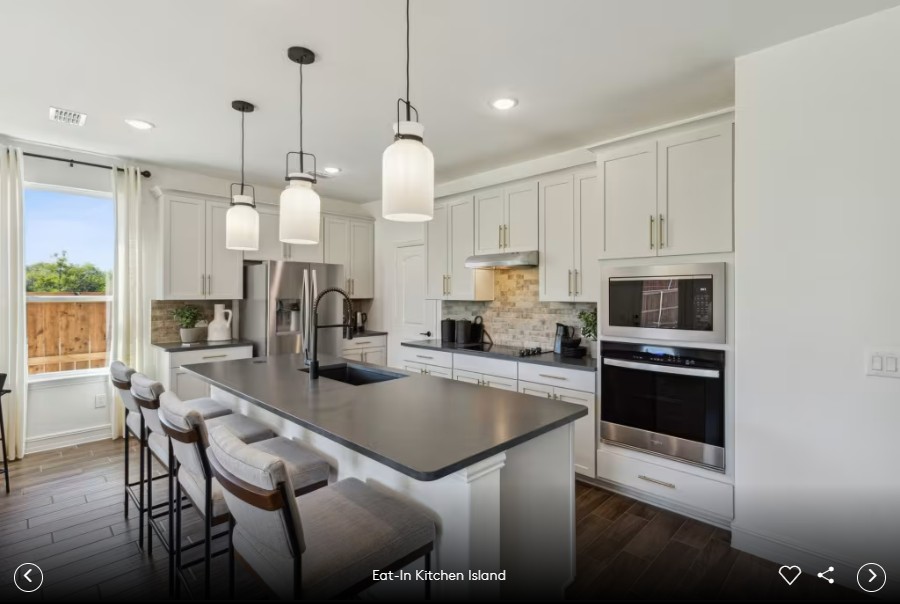 16813 Bustillos Path Manor Manor, TX 78653 - Photo 5 of 15 a kitchen with kitchen island a stove a table and chairs in it