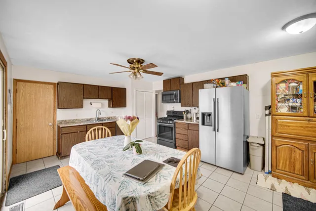 a kitchen with stainless steel appliances granite countertop a refrigerator and a stove top oven