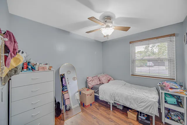 a bedroom with a bed and a chandelier
